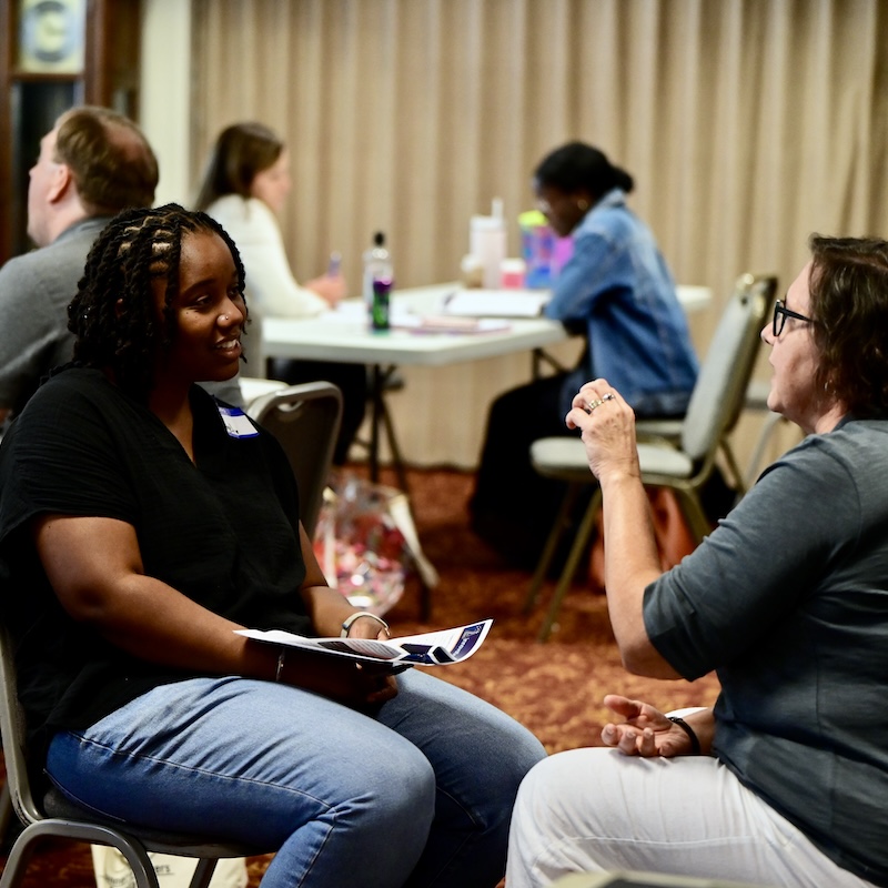Pastor practicing connective labor by listening attentively to a church member during a conversation.