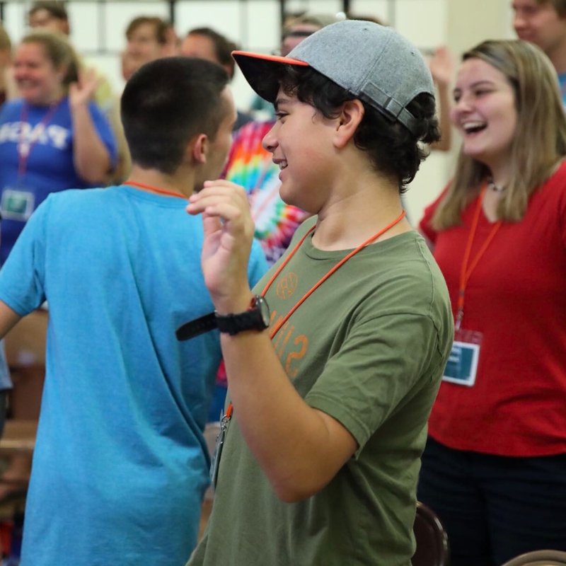 Students laughing and connecting during a youth ministry retreat activity, illustrating the community-building impact of intentional retreat planning.