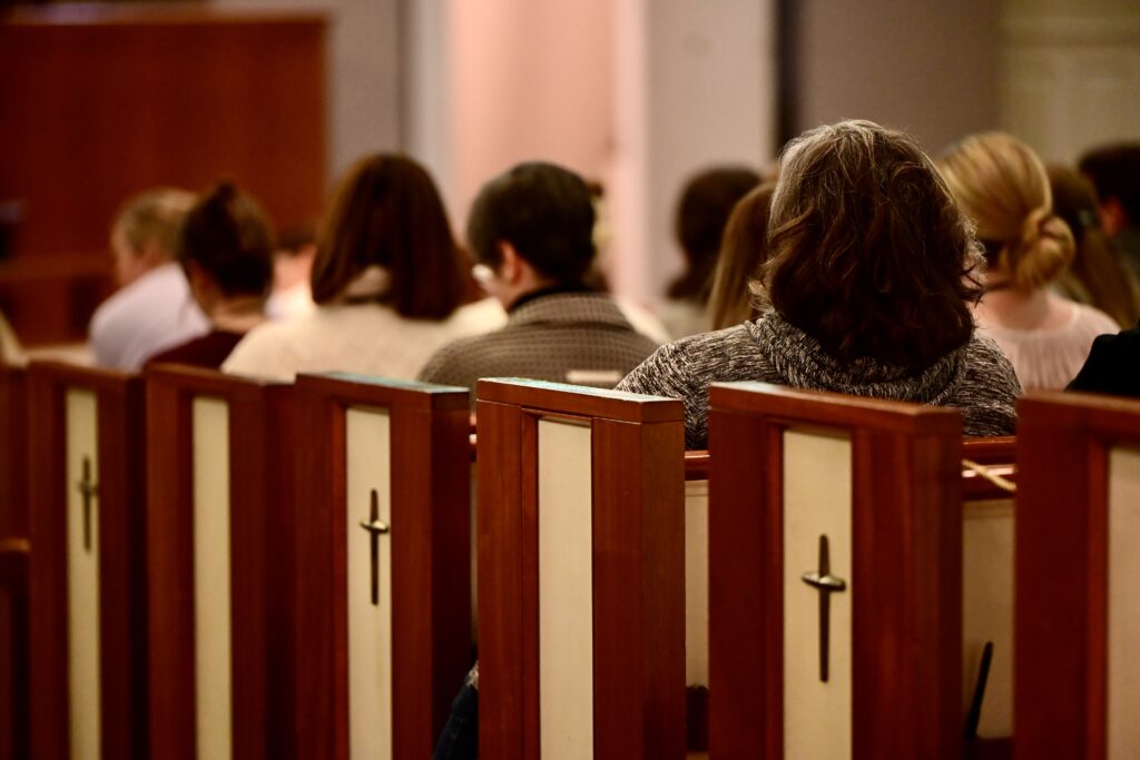 white church pews with a cross on ends and with wood around the borders